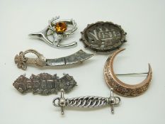 A yellow metal Victorian crescent brooch, a silver and agate knife brooch,