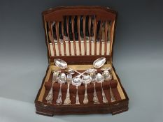 An oak canteen of plated Kings pattern cutlery and a pair of tablespoons