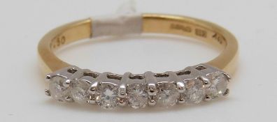 An 18ct gold ring set with seven diamonds totalling approxiamtely 0.25ct, 3.