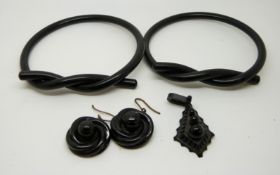 Two Victorian jet flapper/slave bangles, a jet pendant and a pair of carved jet earrings.