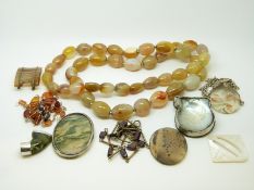 A yellow metal and amber necklace, agate beaded necklace, a necklace set with garnet beads,