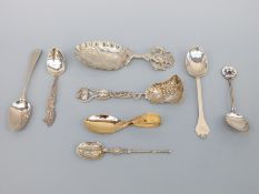A quantity of hallmarked silver spoons, including a part gilt foliate shovel shaped example,