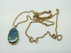 A 9ct gold necklace set with a black opal on a 9ct gold chain, 4.
