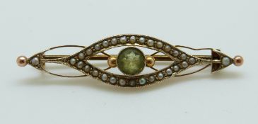 A 9ct gold Edwardian brooch set with a peridot and seed pearls 4.3cm, 2.