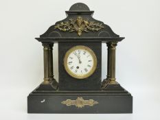 A Victorian slate mantel clock with Romanesque architectural case,