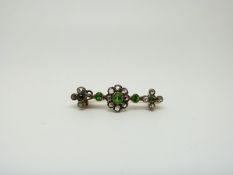 An early Victorian brooch set with rose cut diamonds and tsavorite demantoid garnets,