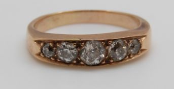 A 9ct gold ring set with five graduated old cut diamonds, centre diamond approximately 0.