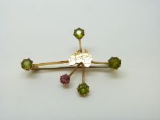 A 15ct gold brooch set with peridot and a pink topaz with an outline of Australia to the centre