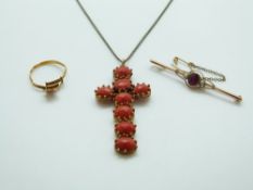 A yellow metal cross set with rose cut oval coral cabochons,