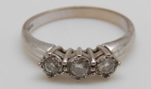 An 18ct white gold ring set with three diamonds (size O)