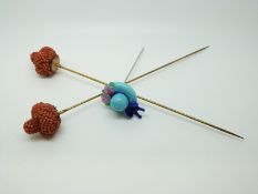 Two Victorian coral hat pins in the form of a crown with a glass hat pin in the form of a hat