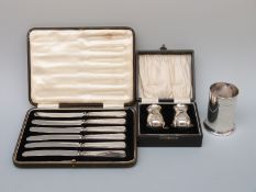 A hallmarked silver spill holder, Birmingham, a cased pair of peppers,