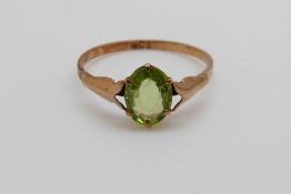 A 9ct gold ring set with an oval peridot (size P)