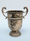 An Edward VII twin handled trophy or similar cup, London 1906 maker's mark rubbed, height 12.