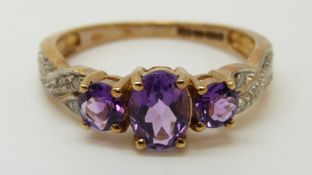 A 9ct gold ring set with amethysts and diamonds (size O)
