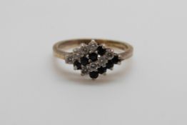 A silver ring set with sapphires and cubic zirconia (size J)