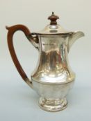 A George V hallmarked silver hot water jug, Birmingham 1930, maker Harford Case Co.