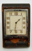 A c1920 LeCoultre Art Deco style travel clock with square Arabic dial and luminous hands,