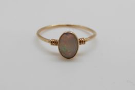 A 9ct gold ring set with an opal cabouchon (size J)