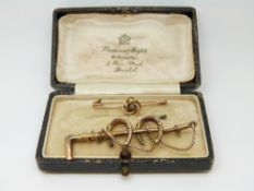 A Victorian brooch in the form of a crop and horseshoes and a yellow metal brooch in Bristol