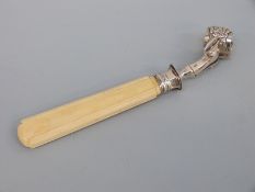 A French white metal ivory handled ham holder or clamp, with lion's claw decoration to clamp,