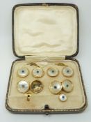 A cased set of 9ct gold cufflinks and studs set with mother of pearl and a blue cabochon to each
