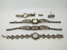 Three silver and marcasite watches a marcasite bracelet and a silver and marcasite ring set with a