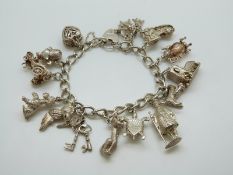 A silver charm bracelet with 13 charms including cat, owl, dog, turtle,