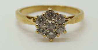 An 18ct gold ring set with diamonds in a cluster, total diamond weight approximately 0.5ct, 3.