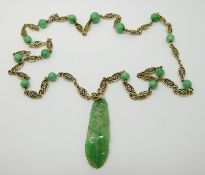 A 14ct gold filigree necklace set with jadeite beads and a carved jadite plaque