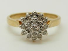 An 18ct gold ring set with diamonds in a cluster, total diamond weight approximately 0.15ct, 3.