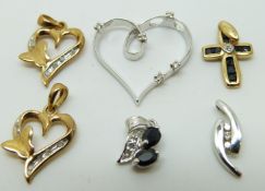 A 9ct white gold pendant in the form of a heart set with diamonds,