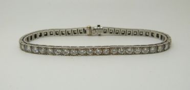 A Tiffany & Co palladium tennis bracelet set with 50 round brilliant cut diamonds each