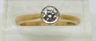 An 18ct gold ring set with a round cut diamond of approximately 0.23ct, 3.
