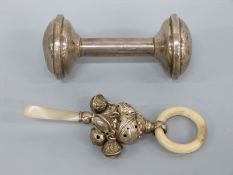 A George V hallmarked silver and mother of pearl baby's rattle, Birmingham 1915 maker's mark rubbed,
