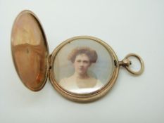 A Victorian yellow metal locket with painted portrait within, 18.