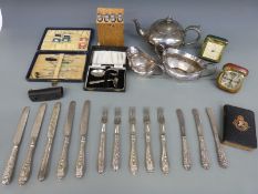 A collection of silver plated cutlery, plated tea ware, travelling clocks,