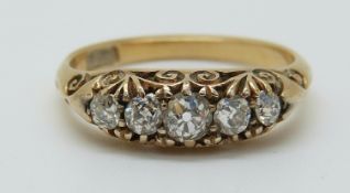 An 18ct gold ring set with five graduated old cut diamonds, 2.