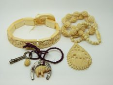 A carved ivory bracelet depicting elephants and an ivory necklace