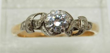 An 18ct gold ring set with a diamond of approximately 0.