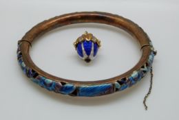 An egg pendant set with blue and white enamel together with a white metal pierced bangle set with