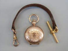 An 18ct rolled gold sovereign case with engraved decoration and a leather watch chain with 18ct