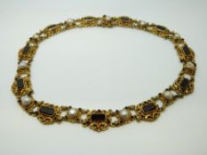 A 19thC Austro-Hungarian necklace set with pearls and garnets in an ornate setting