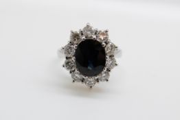 An 18ct white gold ring set with an oval sapphire of approximately 1.
