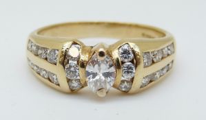 A 14ct gold ring set with a marquise cut diamond surrounded by round cut diamonds, 4.