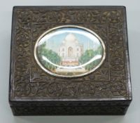 An early 20thC Anglo Indian carved ebony box with inset oval miniature of the Taj Mahal,