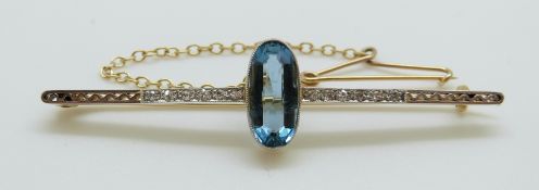 A 15ct gold brooch set with an oval cut aquamarine and diamonds with a platinum finish 5.6cm , 4.