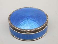 A white metal and blue guilloché enamel hinged compact or pill box with seed pearl border with