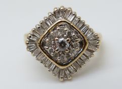 A 9ct gold ring set with round cut and baguette cut diamonds in a cluster, 4.