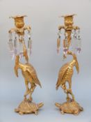 A pair of 19thC gilt bronze candelabra in the form of cranes on turtles in the Japanese style,